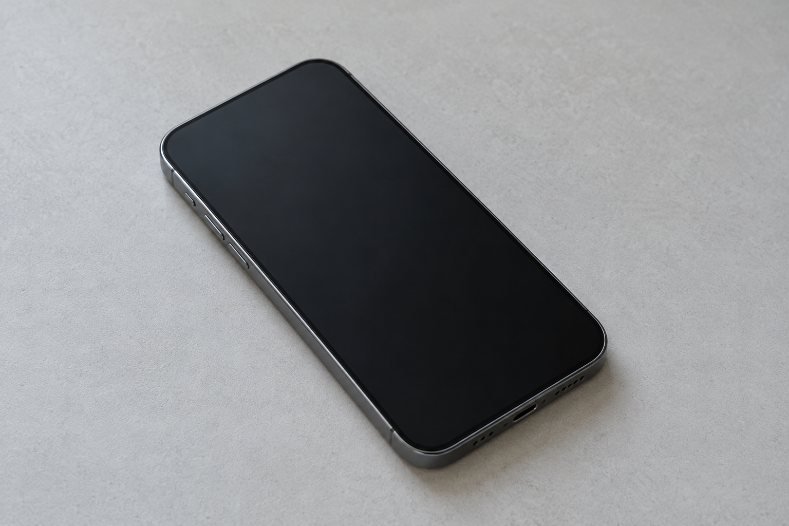 An unbranded smartphone on a plain desk, screen dark, with no logo and no second device.